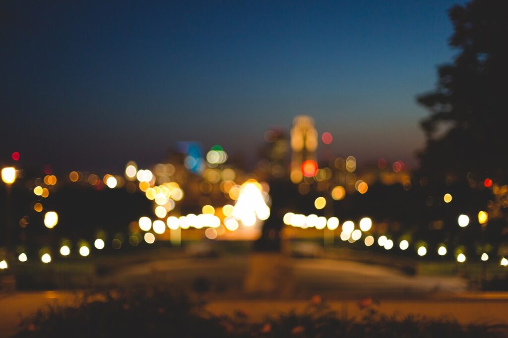 A blurred image of a city and night, with blurred lights and buildings