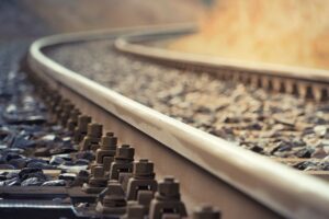 A close up of a railway track, with the foreground in sharp focus, the image becoming more blurred in the background