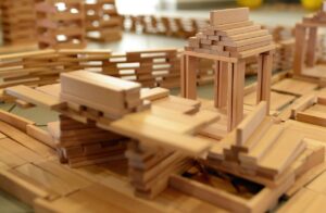 A wooden building set, with partially built items. This shows the building blocks to something better.