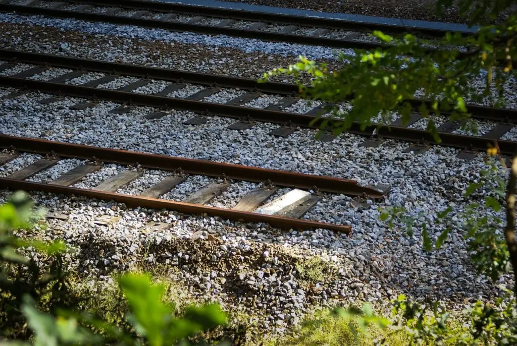 Railway tracks running through the countryside. One of the rails ends suddenly