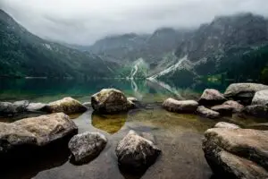 A calm lake, with mist and mountains in the background. This is a sign of the serenity you achieve when you have self-awareness