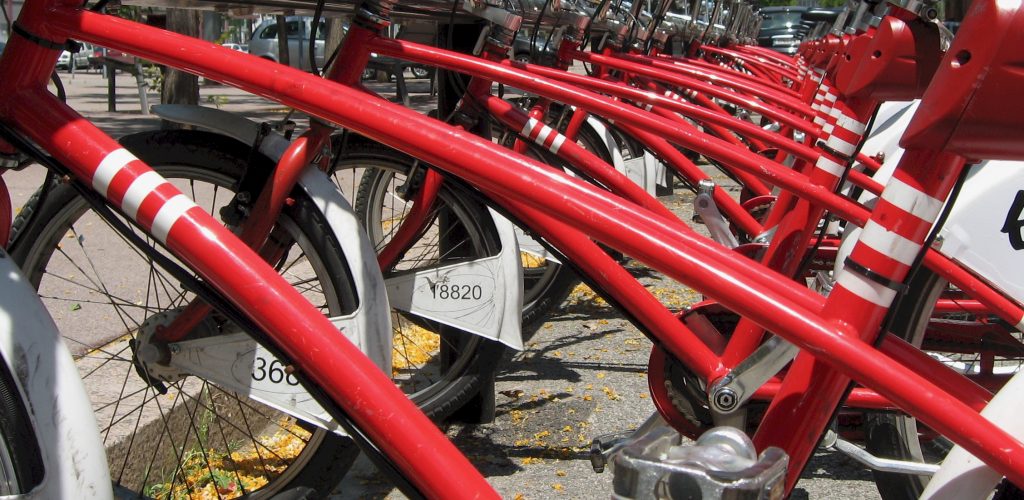 A line of red bikes, lined up and ready to go, symbolic of getting the change you want to be.